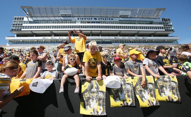 Iowa fans wait for an autograph from the football team during Kids' Day at Kinnick Stadium on Saturday, Aug. 12, 2023, in Iowa City, Iowa