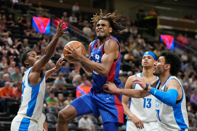 Philadelphia 76ers forward Greg Brown lll, center, goes to the basket as Oklahoma City Thunder's Jared Butler, left, Ousmane Dieng (13) and Hunter Maldonado, right, defend during the first half of an NBA summer league basketball game Thursday, July 6, 2023, in Salt Lake City. (AP Photo/Rick Bowmer)