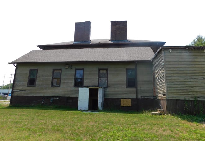 The original wooden schoolhouse still stands and is attached to the back of the building.