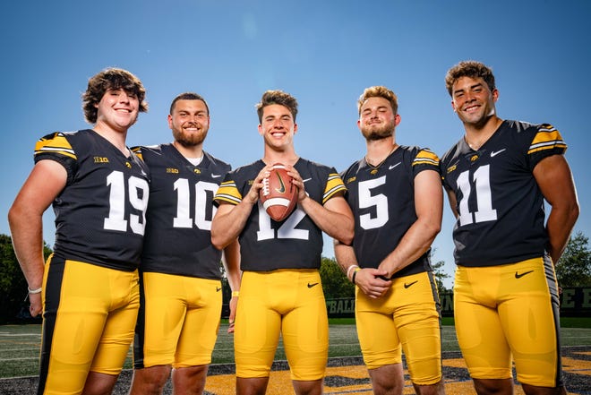 Iowa quarterbacks Tommy Poholsky (#19), Deacon Hill (#10), Cade McNamara (#12), Joe Labas, (5) and Marco Lainez (#11) stand for a photo during Hawkeyes Football media day in Iowa City, Friday, Aug. 11, 2023.