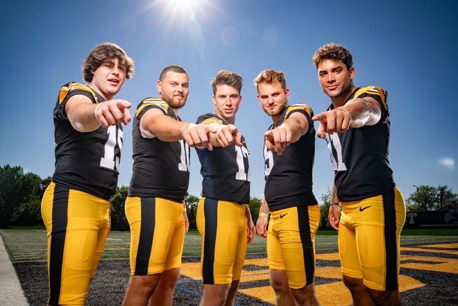 Iowa quarterbacks Tommy Poholsky (#19), Deacon Hill (#10), Cade McNamara (#12), Joe Labas, (5) and Marco Lainez (#11) stand for a photo during Hawkeyes Football media day in Iowa City, Friday, Aug. 11, 2023.