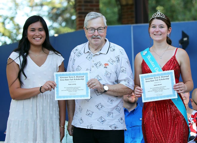 Former Governor Terry Brandstad presents Iowa State Fair Scholarships to Katie Leichty, left, and Hailey Burton of Decatur Country before the annual Iowa State Fair Queen Coronation on the Anne and Bill Riley Stage at the Iowa State Fair on Saturday, August 12, 2023, in Des Moines.