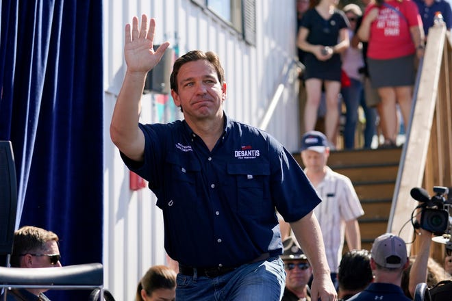 Republican presidential candidate Florida Gov. Ron DeSantis waves as he steps onto the stage for a Fair-Side Chat with Iowa Gov. Kim Reynolds at the Iowa State Fair, Saturday, Aug. 12, 2023, in Des Moines, Iowa. (AP Photo/Jeff Roberson)