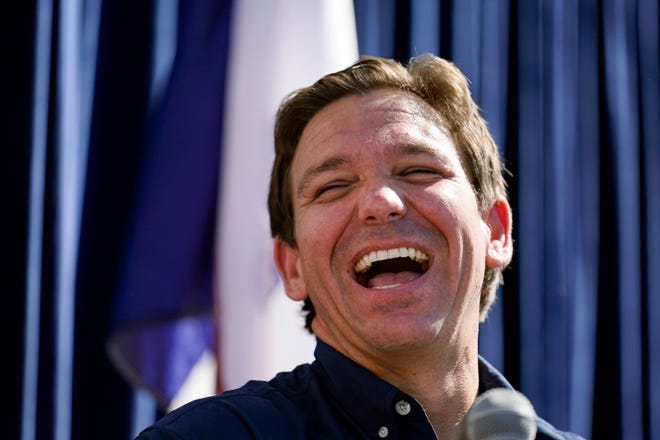 Republican presidential candidate Florida Gov. Ron DeSantis laughs during a Fair-Side Chat with Iowa Gov. Kim Reynolds at the Iowa State Fair, Saturday, Aug. 12, 2023, in Des Moines, Iowa. (AP Photo/Jeff Roberson)