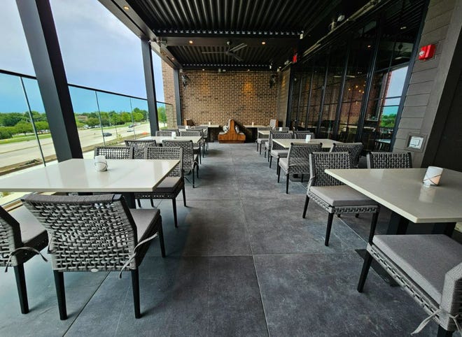 The second-floor patio offers a privacy wall, misters, fans and heaters at Ruth's Chris Steak House in West Des Moines. The 15,000-square-foot restaurant opens on Aug. 14, 2023.