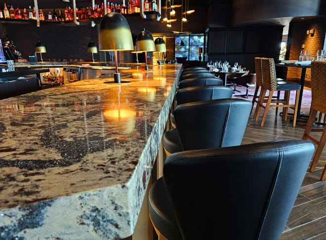 The second-floor bar has backlit bottles overhead and 25 seats at Ruth's Chris Steak House in West Des Moines. The 15,000-square-foot restaurant opens on Aug. 14, 2023.