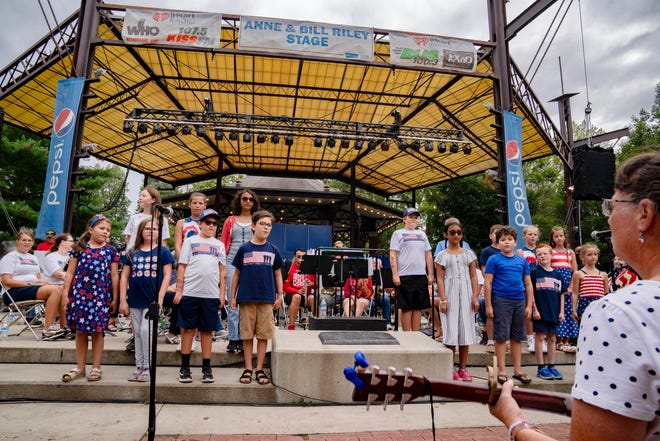 Children sing during a military tribute concert at the Anne and Bill Riley Stage during the Iowa State Fair, Monday, Aug. 14, 2023.