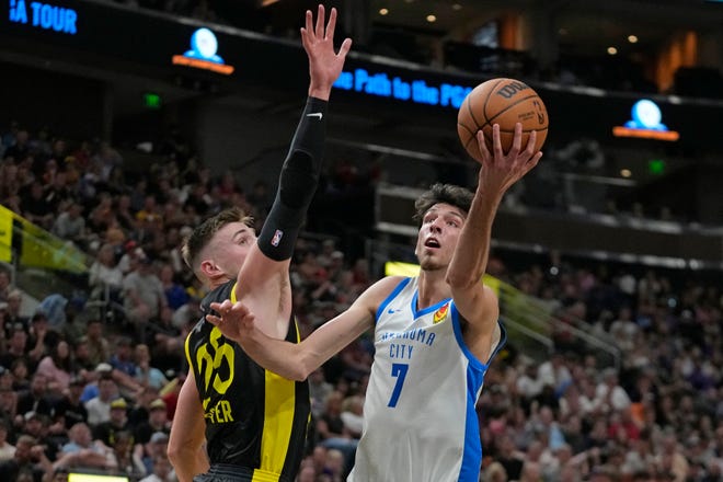Oklahoma City Thunder forward Chet Holmgren (7) goes to the basket as Utah Jazz's Micah Potter (25) defends in the first half during an NBA Summer League basketball game Monday, July 3, 2023, in Salt Lake City. (AP Photo/Rick Bowmer)