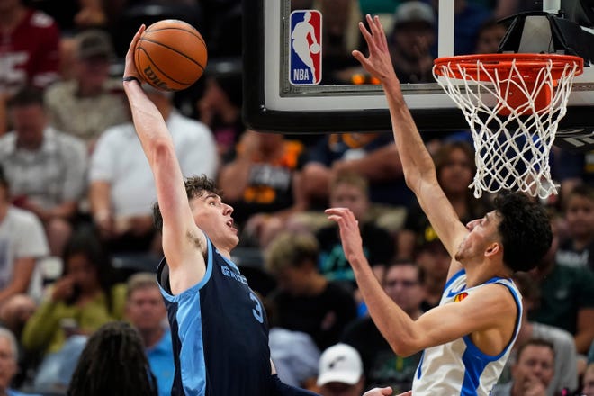 Memphis Grizzlies forward Jake LaRavia (3) goes to the basket as Oklahoma City Thunder forward Chet Holmgren defends during the second half of an NBA summer league basketball game Wednesday, July 5, 2023, in Salt Lake City. (AP Photo/Rick Bowmer)