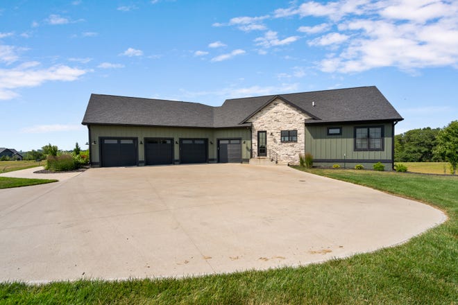 Make yourself at home in this custom-built house in Winterset. The modern home offers 4,435 square feet of living space with a patio and deck area, as well as a separate guest house on the same property.